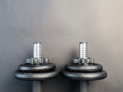 Pair of heavy dumbbells on a rubber gym mat